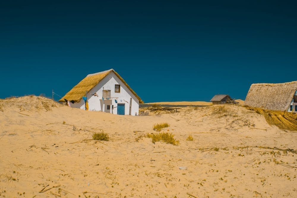 Photo of white house on sand beach in Valizas in Uruguay.